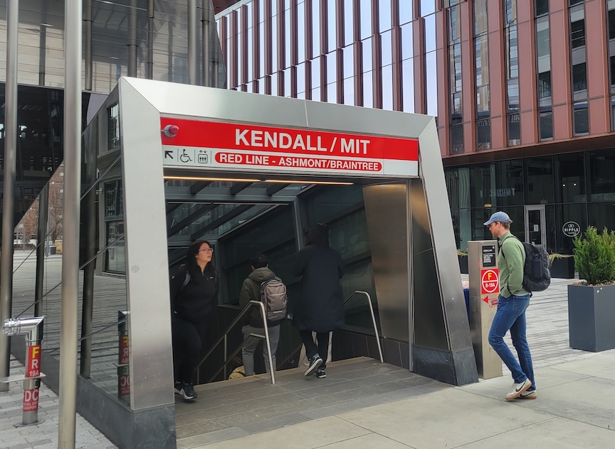 People enter and exit the MIT Kendall T stop.