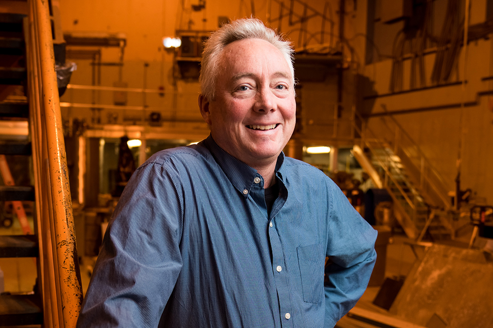 Prof Dennis Whyte standing in a lab, MIT